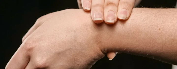 Person holding a painful wrist