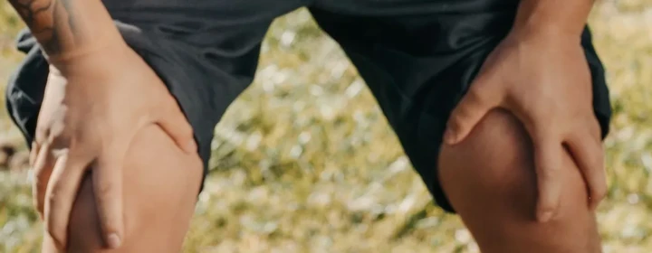 Person holding a painful knee