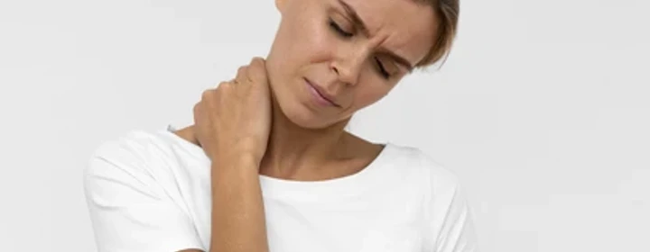 Woman holding her sore neck